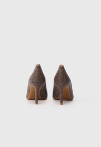 Chaussures à talons hauts marron avec un motif texturé, bout pointu et un talon aiguille fin, présentant un petit logo à l'arrière.