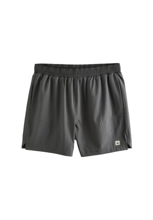 Tamnosive sportske kratke hlače s elastičnim strukom, bočnim džepovima, malim bočnim prorezima i logotipom na donjoj lijevoj nozi.