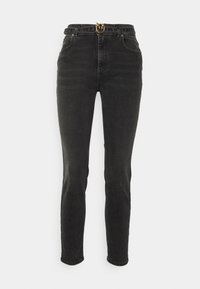 Svarta högmidjade skinny jeans med framfickor och ett svart bälte med en guldspänne format som två fåglar som vänder sig mot varandra.