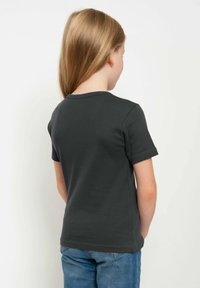 Dark gray short-sleeve t-shirt with a round neckline, simple design, and smooth texture, paired with blue jeans, viewed from the back.