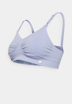 Reggiseno in morbido tessuto lilla con centro arricciato, spalline regolabili e un accento metallico rotondo. Texture liscia, design senza cuciture.