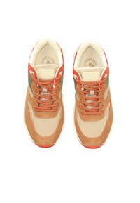 Beige mesh sneakers with brown suede details, green and orange accents, and textured laces. Features a padded collar and logo on the tongue.