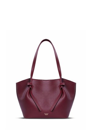 Burgundy tote bag with a textured leather finish, featuring a wide silhouette, knotted handle details, and a metallic logo accent.