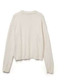 Sweter w kolorze kremowym, dziergany, z krótkim krojem, ściągaczami przy mankietach i u dołu. Miękka tekstura i rękawy raglanowe, widoczne szwy na ramionach.
