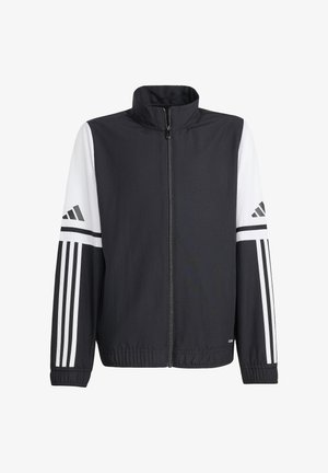 Veste zippée noir et blanc avec un col haut, dotée de manches contrastantes et d'un logo à trois rayures sur les bras, fabriquée en tissu léger.