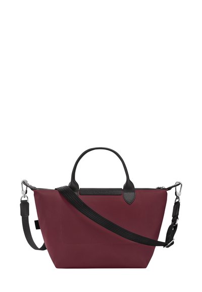 Maroon tote bag with black leather trim and accents. Features dual handles and a detachable shoulder strap. Made of smooth, durable material.