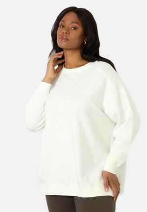 Oversized witte sweatshirt van zacht materiaal, met een ronde hals, lange raglanmouwen en ribgebreide boorden en onderrand.