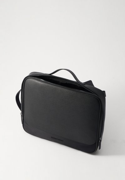 Black leather briefcase with a smooth texture, rectangular shape, top zipper closure, and handles on the top and side.