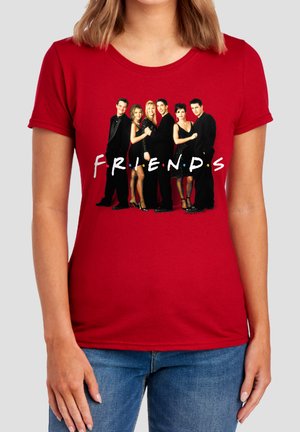 Red shirt with six people standing closely together in black outfits above the word "FRIENDS" in stylized white letters.