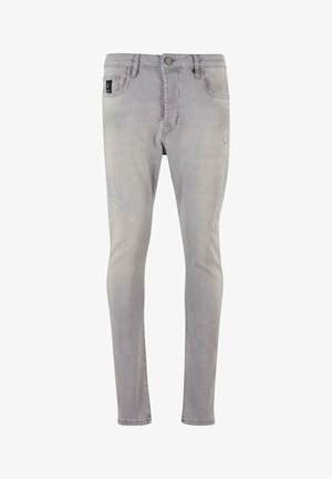 Hallux denim püksid kitsas lõikega, nuppude sulgemisega ja kerge kulumisega põlvedel, andes neile kandmise väljanägemise.