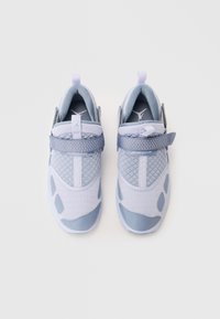 Light blue athletic shoes with a mesh upper, textured accents, padded collar, and a velcro strap labeled "JORDAN." Smooth rubber sole.