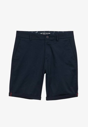 Tumši zilie šorti, kas izgatavoti no viegla auduma, ar slīpām kabatām, ruļļveida malām un kontrastējošu sarkanu akcentu uz jostasvieta.