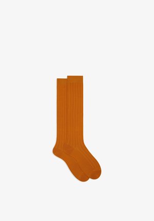 Orange knee-high socks with a ribbed texture, featuring a solid color and slightly reinforced toe and heel areas.