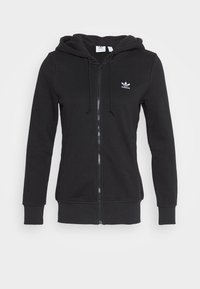 Svart zip-up hoodie i mjuk bomullsblandning, med en dragsko i huvan och en liten vit Adidas-logotyp på vänster bröst.