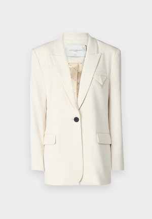 Ivory blazer with a structured design, featuring a single black button, notch lapels, and two front pockets. Subtle geometric accent on the chest.