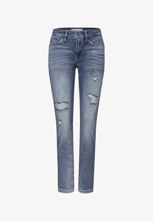 Jeans skinny bleus avec des détails délavés et des patchs usés sur les cuisses et les genoux, dotés d'une fermeture à bouton et à glissière.
