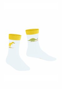 Weiße Socken mit einem gelben Rippbündchen, das ein gelbes Dinosaurier- und ein grünes Stegosaurus-Muster zeigt. Weicher Textil, in halblanger Ausführung bis zur Wade.