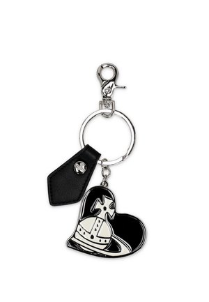 Portachiavi in metallo con targhetta in pelle nera e ciondolo a forma di cuore bianco e nero con un design stilizzato di corona e croce.