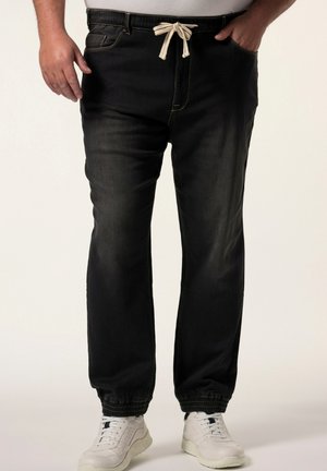 Joggers de mezclilla negra con cinturilla elástica, cordón ajustable y puños elásticos. Presenta costuras en contraste y bolsillos laterales.