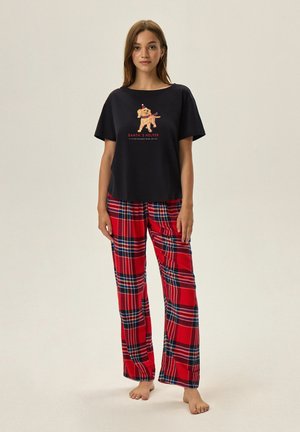 Navy cotton T-shirt with a graphic of a dog and text; red plaid flannel pants with blue and white detailing; relaxed fit, soft texture.