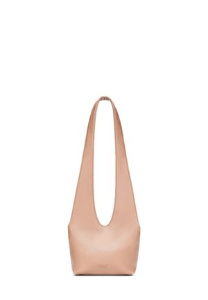 Blush leather shoulder bag with a wide, cut-out handle and a rounded base. Smooth texture, minimalist design, and subtle logo detail at the base.