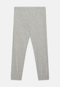Leggings en coton gris avec une taille élastique, design ajusté et poignets froncés aux chevilles. Texture douce avec une finition lisse.