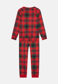 Rode en groene geruite pyjama's met lange mouwen, elastische taille en ribgebreide manchetten. Heeft een zachte textuur en een comfortabele pasvorm.