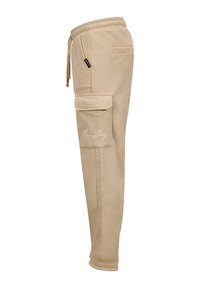 Beige cargobroek met elastische tailleband, koordsluiting, zijzakken en geborduurde details. Soepele textuur en tapered leg ontwerp.