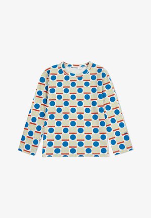 Long-sleeve shirt in white fabric featuring bold blue circles, yellow grids, and red horizontal lines in a repeating geometric pattern.