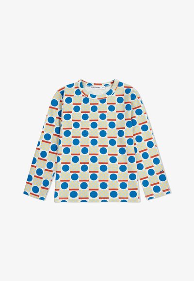 Košulja dugih rukava od bijelog materijala s odvažnim plavim krugovima, žutim mrežama i crvenim horizontalnim linijama u ponavljajućem geometrijskom uzorku.
