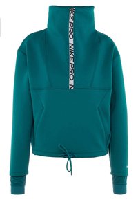 Pull à manches longues couleur sarcelle avec col zippé haut, doté d'un ruban noir avec logo Nike Pro et d'un ourlet ajustable avec cordon de serrage.