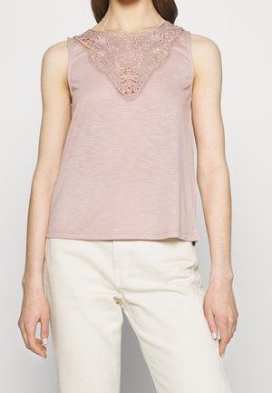 Mouwloos roze top met een textuur en kanten halslijn detail. Lichtgewicht stof, ontspannen pasvorm. Combinatie met ivoorwitte broek.