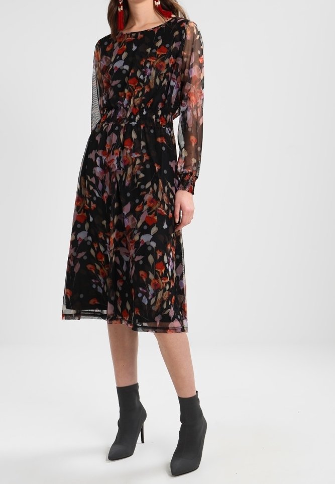 Černé květinové šaty s dlouhými průsvitnými rukávy, elastickým pasem a vrstvenou látkou. Mají vícebarevný květinový vzor a délku po kolena.
