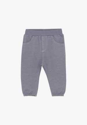 Grå tygbyxor med en ribbad midja, elastiska manschetter och två framfickor. Kontraststygn längs sömmarna. Mjuk textur.