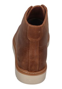 Braune Leder-Ankle-Boots mit glatter Textur, verstärkter Ferse und hellem Gummisohle. Mit einer kleinen Lasche hinten.