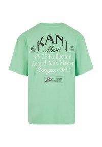 Mint green t-shirt made of cotton, featuring black and white printed text: "KAN1 Music," and design details from the S/S '25 Collection.
