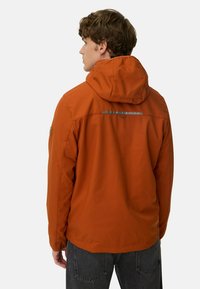 Orange waterproof jacket with a hood, featuring a reflective strip across the back, textured fabric, and elastic cuffs.