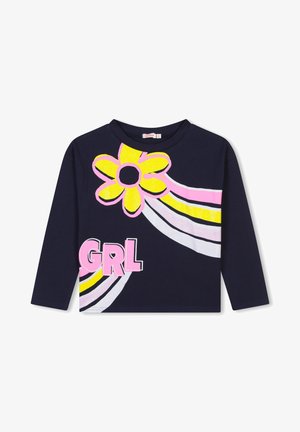 Marineblaues Langarmhemd mit großer gelber Blume, rosa und weißen geschwungenen Streifen und rosa Buchstaben "GRL" vorne.