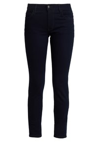 Jeans ajustados en denim azul oscuro, con una cintura de altura media, diseño de cinco bolsillos y costuras sutiles en las costuras para un detalle adicional.