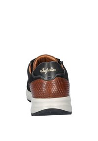 Black leather sneaker with brown textured accent at heel, white midsole, and tan interior. Subtle logo on the back.