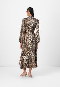 Leopardtryk kjole i satinmetervarer, lange puffærmer, bælte i taljen, svajende sømhæng med fin flare, farver der spænder fra beige til mørkebrun.