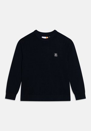 Pull en tricot bleu marine avec un col rond, des manches longues, des poignets et un ourlet côtelés, arborant un petit logo de marque sur la poitrine.