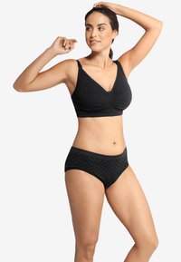 Svart behå med V-ringning, strukturerad tyg och spetsdetaljer, tillsammans med matchande svarta rutiga trosor med en mjuk midjeband.