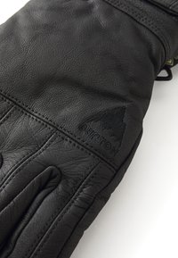Guanto in pelle nera con logo Burton impresso, caratterizzato da dettagli cuciti e una finitura texturizzata. Progettato per offrire calore con una vestibilità aderente.