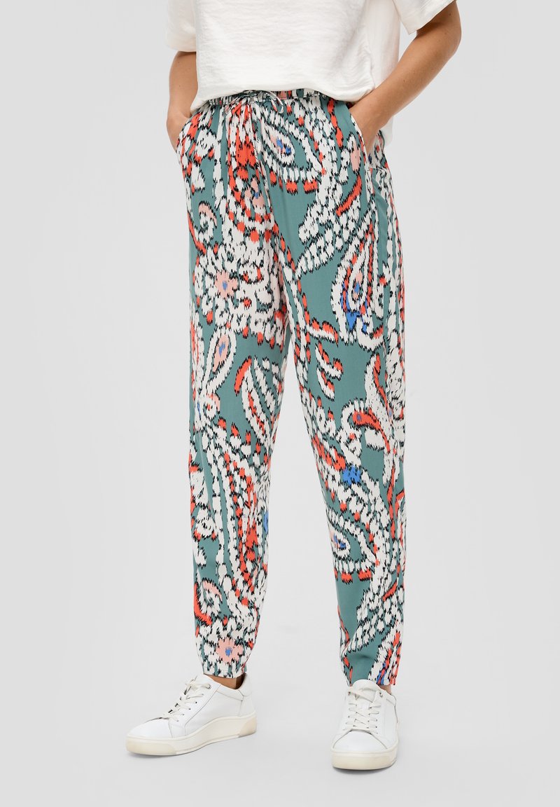 Spodnie w turkusowym kolorze z wzorem paisley, zawierające odcienie czerwieni i bieli. Elastyczny pas i boczne kieszenie. Luźny krój.