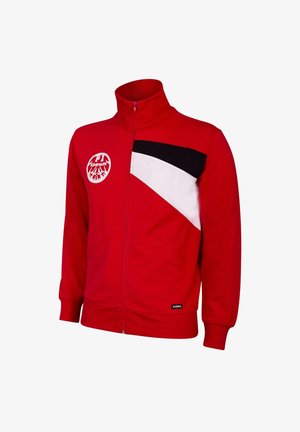 Red zip-up jacket features a white and black diagonal design, patch pockets, and a round logo on the left chest. Soft fabric texture.