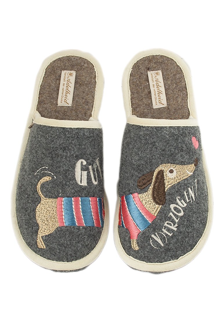Gray felt slippers with cream trim and a dachshund design. Features embroidered stripes in red and blue, with text “GUT VERZOGEN.”