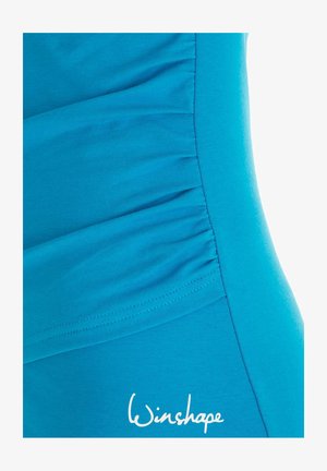 Turquoise fabric swimwear featuring side ruching for texture, smooth finish, and a white "Winshape" logo at the bottom.