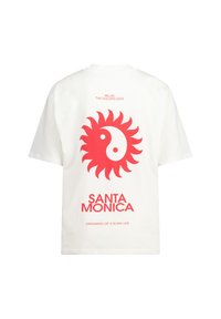 White cotton t-shirt featuring a large red sun and yin-yang graphic on the back, with the text "SANTA MONICA" and "DREAMING OF A SLOW LIFE."