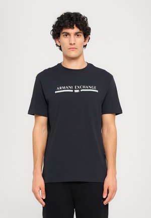 Dark blue cotton t-shirt with short sleeves, round neckline, and white "Armani Exchange 1991" logo printed across the chest.